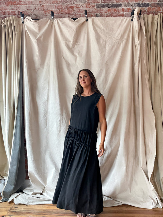 Sleeveless black midi dress with cinch detail